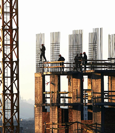 Construction Workers at a High Rise